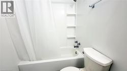 Tub and shower combination featuring integrated shelving and chrome fixtures - 