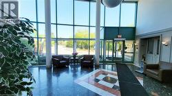 Two-story glass façade with dark green framing and multiple entrances - 