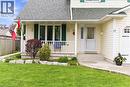 Exterior featuring light-colored siding, a covered front porch, and a dedicated garage entrance - 17 Piper Place, Caledonia, ON 