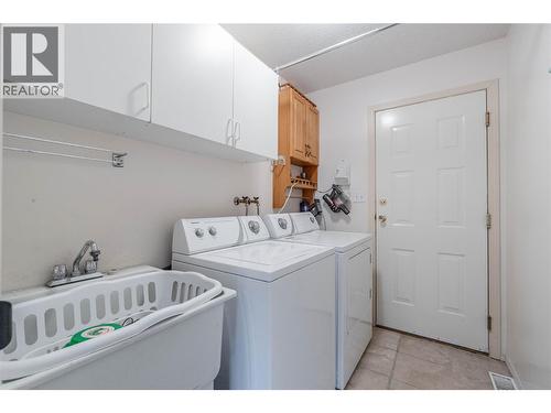 Laundry room - main level with access to garage - 6763 Meadows Drive, Oliver, BC - Indoor Photo Showing Laundry Room