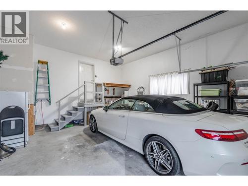 Garage with stairs to enter laundry room. - 6763 Meadows Drive, Oliver, BC - Indoor Photo Showing Garage