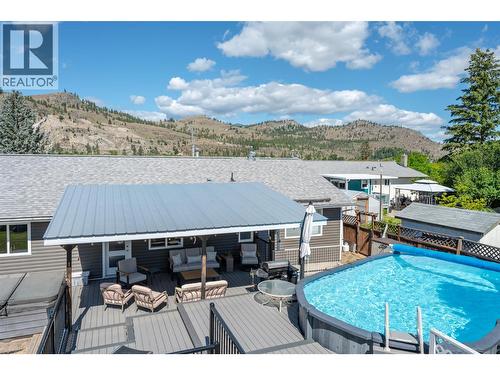 View from top of yard - 6763 Meadows Drive, Oliver, BC - Outdoor With Above Ground Pool With Deck Patio Veranda