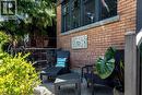 Brick facade with dark-framed windows, a decorative wall panel, and a concrete window sill - 99 Hillcrest Avenue, Hamilton, ON 