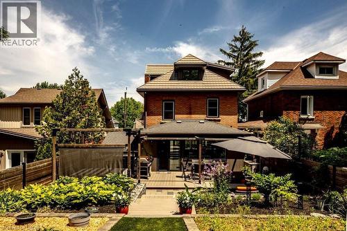 Spacious backyard featuring a multi-level deck, a pergola, and extensive landscaping - 99 Hillcrest Avenue, Hamilton, ON 