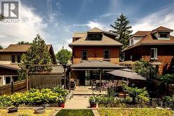 Spacious backyard featuring a multi-level deck, a pergola, and extensive landscaping - 