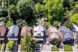 Aerial perspective showcasing a residential street with mature tree canopies - 