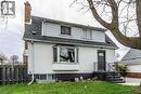 Exterior featuring a bay window, asphalt shingle roof, and brick chimney - 20 West 1St Street, Hamilton, ON 