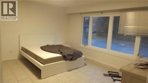 Room with light-toned tile flooring and white walls - 68 Austin Drive, Waterloo, ON - Indoor Photo Showing Bedroom