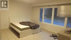 Room with light-toned tile flooring and white walls - 