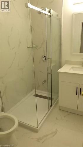 Shower enclosure featuring clear glass panels and a linear drain - 68 Austin Drive, Waterloo, ON - Indoor Photo Showing Bathroom