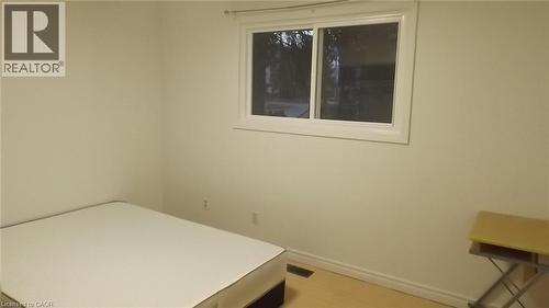 Room featuring a white-framed window, neutral wall paint, light-toned flooring, and white baseboards - 68 Austin Drive, Waterloo, ON - Indoor