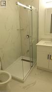 Shower enclosure featuring clear glass panels and a linear drain - 
