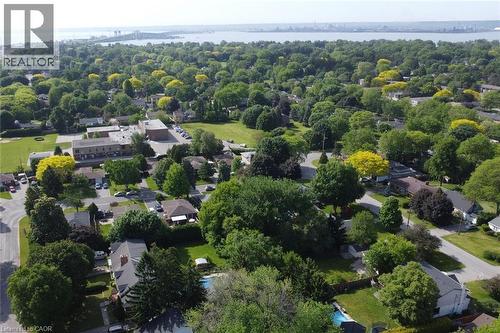 Drone view highlighting a fantastic neighbourhood location, school just steps away and the lake nearby. - 945 Glen View Avenue, Burlington, ON 