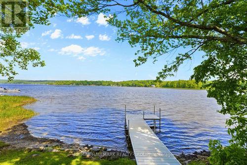 Private dock extending into calm lake - 118 Hall Shore Road, Lanark Highlands, ON 