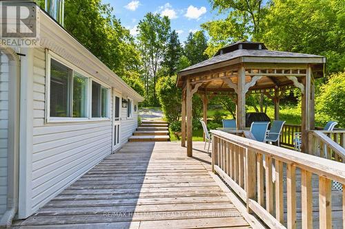 Wraparound deck connecting outdoor spaces - 118 Hall Shore Road, Lanark Highlands, ON 