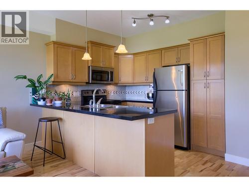 Kitchen with room for guests to pull up a stool - 3533 Carrington Road Unit# 206, West Kelowna, BC 