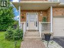 Brick-clad exterior featuring a covered porch entry with white columns and railings - 2229 Walkers Line Unit# 6, Burlington, ON  - Outdoor With Deck Patio Veranda 