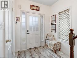 White paneled entry door with frosted glass inserts and sidelights - 