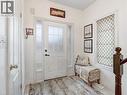 White paneled entry door with frosted glass inserts and sidelights - 2229 Walkers Line Unit# 6, Burlington, ON  - Indoor Photo Showing Other Room 
