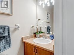 Bathroom vanity with a white drop-in sink, chrome faucet, and wood-finish cabinetry - 