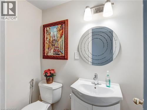 Bathroom featuring a white toilet, white vanity with integrated sink, and an overhead light fixture - 2229 Walkers Line Unit# 6, Burlington, ON - Indoor Photo Showing Bathroom