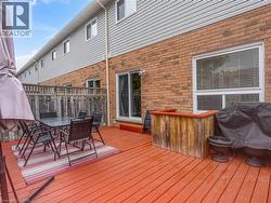 Spacious outdoor deck featuring finished decking and a privacy fence - 