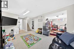 Lower-level room featuring carpet flooring, recessed lighting, and a neutral color palette - 