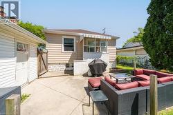 Concrete patio area with a detached garage and a fenced perimeter - 