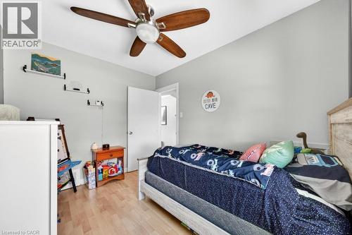 Light wood-finish flooring with a ceiling fan featuring wood blades - 420 Upper Gage Avenue, Hamilton, ON 