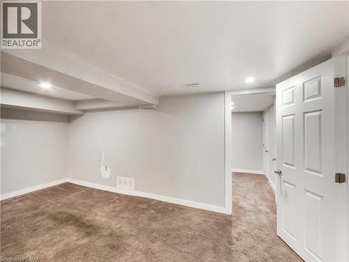 Carpeted room with recessed lighting and exposed ceiling beams - 229 Parkdale Avenue N, Hamilton, ON 