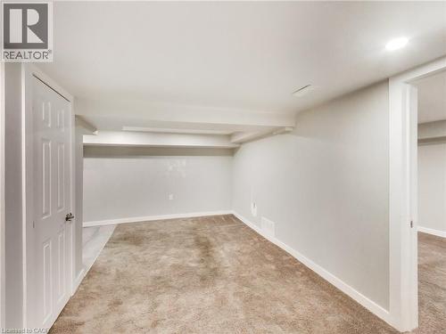 Spacious interior room featuring light-colored walls, recessed ceiling lighting, and neutral-toned carpeting - 229 Parkdale Avenue N, Hamilton, ON 