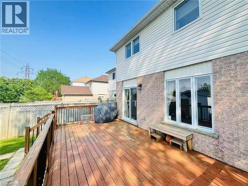 Expansive wood-finish deck with dark wood railing - 136 Hidden Creek Drive, Kitchener, ON 
