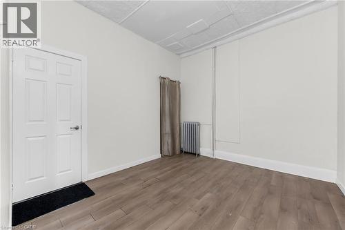 Room featuring wood-finish flooring and neutral wall tones - 1371 Main Street E, Hamilton, ON - Indoor Photo Showing Other Room