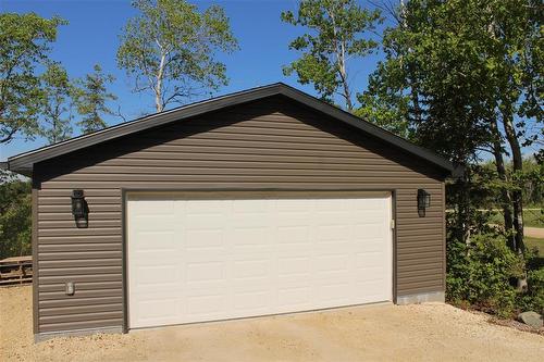 Garage measures 26.4 x 24.4. Has a "smart" garage door opener that you can open with your phone! Great for additional storage and perfect for Manitoba winters. - 7 Dalvik Road, Gimli Rm, MB 