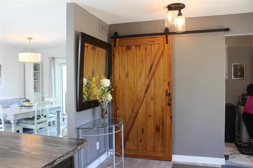 Behind the barn door is additional storage or could be used as a pantry. - 7 Dalvik Road, Gimli Rm, MB 