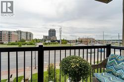 Balcony with black metal railings overlooking a commercial area - 