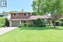 Brick and stone facade residence featuring a front lawn and paved driveway - 372 Fennell Avenue W, Hamilton, ON 