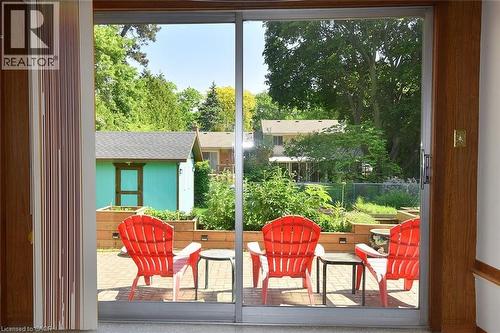 Glass sliding doors opening to an outdoor paver patio - 372 Fennell Avenue W, Hamilton, ON 