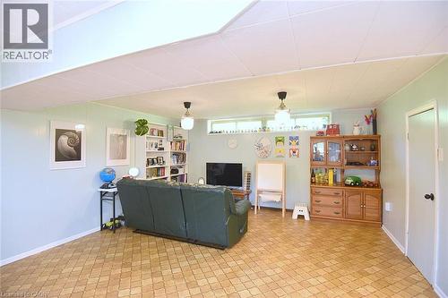 Finished basement space featuring light blue walls and patterned flooring - 372 Fennell Avenue W, Hamilton, ON 