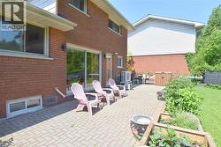 Expansive paver patio with direct access to interior spaces through a sliding glass door - 