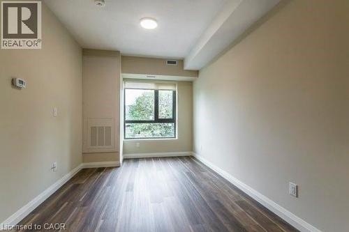 Spare room with dark wood finished floors and baseboards - 580 Coldstream Drive Unit# 307, Waterloo, ON 