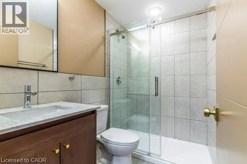 Bathroom with vanity, tile walls, and a shower stall - 580 Coldstream Drive Unit# 307, Waterloo, ON 