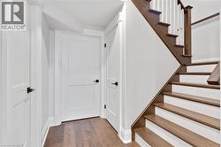 Hardwood staircase with painted risers and balusters - 