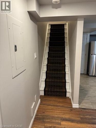 Staircase with patterned runner, white risers, and wood-finish flooring - 113 Cornerbrook Crescent Unit# 2, Waterloo, ON 