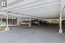 Covered parking leading to entrance of the building - 