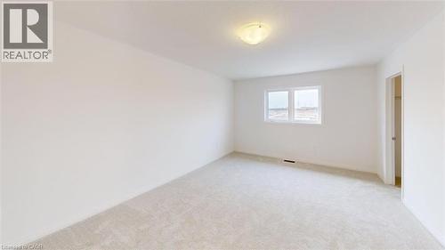 Bright room featuring light-colored carpeting, white painted walls, and a flush-mount ceiling light fixture - 287 Rockledge Drive, Hamilton, ON 
