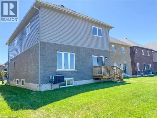 Back exterior of a two-story residence featuring gray brick and horizontal siding - 287 Rockledge Drive, Hamilton, ON 