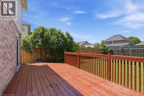 Expansive wood deck with a red stain finish, featuring a matching railing system - 43 Decaro Crescent, Cambridge, ON 