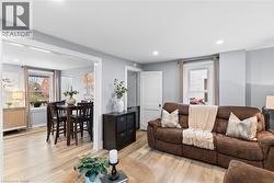 Living room featuring wood-finish flooring and recessed lighting - 
