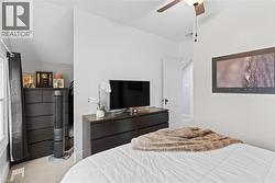 Interior room featuring a ceiling fan with integrated lighting, neutral wall paint, and light-toned carpeting - 
